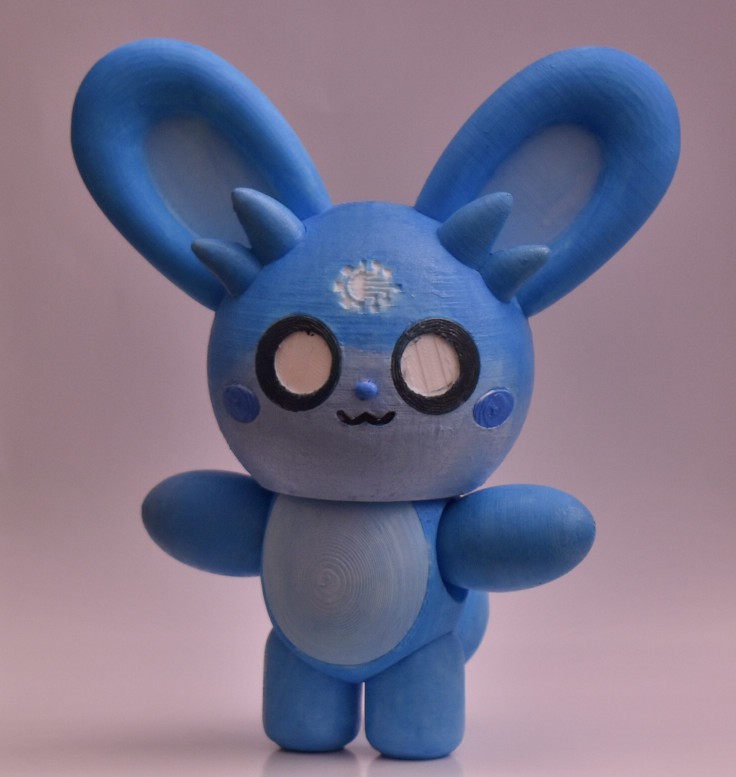 A 3D-printed articulated plastic figurine of Blubunny, a character designed by snowcone-artist