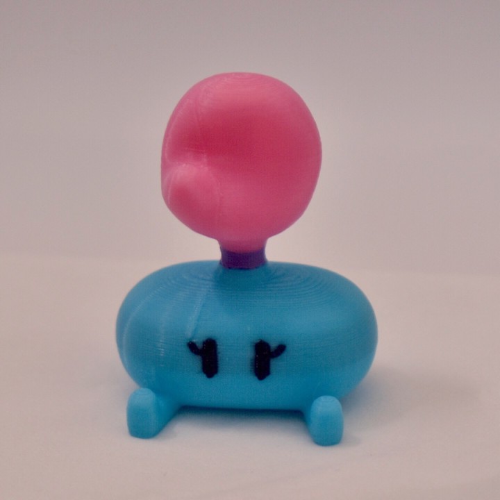 A photo of a small, multi-colored 3D-print of Tossly, a character designed by TVAserd